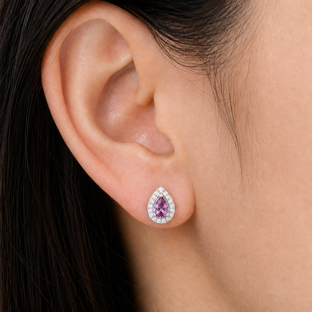 Purple Pear Halo Stud Earrings in 925 sterling silver, worn on the ear