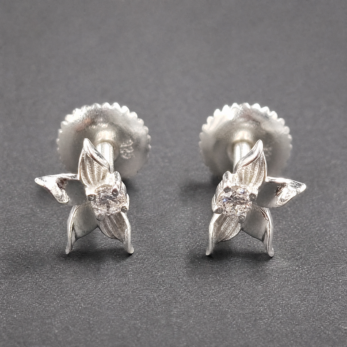Petal Bloom Stud Earrings in 925 sterling silver, on a dark background
