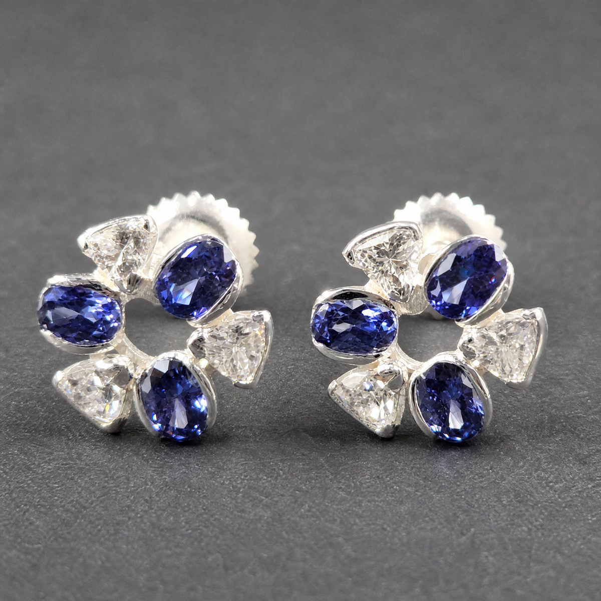Blue and Clear Flower Stud Earrings in 925 sterling silver, on a dark background