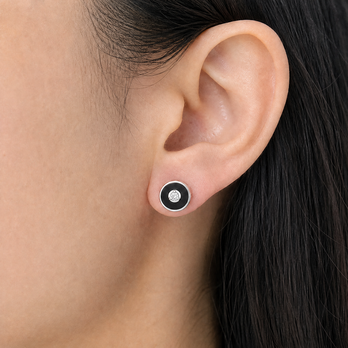 Black Enamel Disc Stud Earrings in 925 sterling silver, worn on the ear