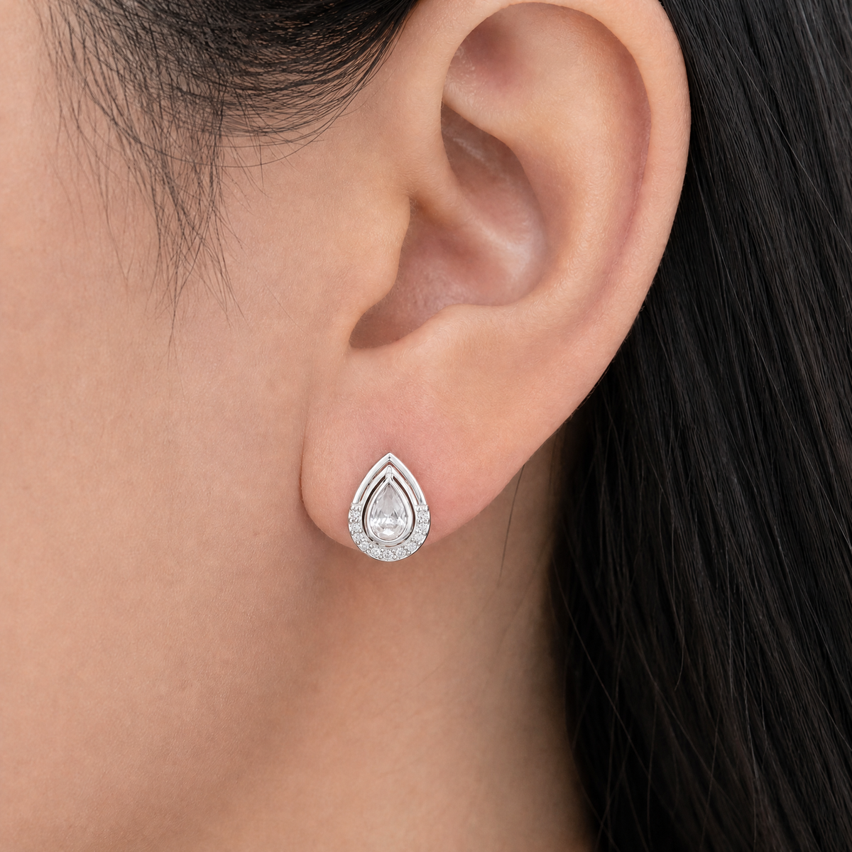 Pear Halo Frame Stud Earrings in 925 sterling silver, worn on the ear