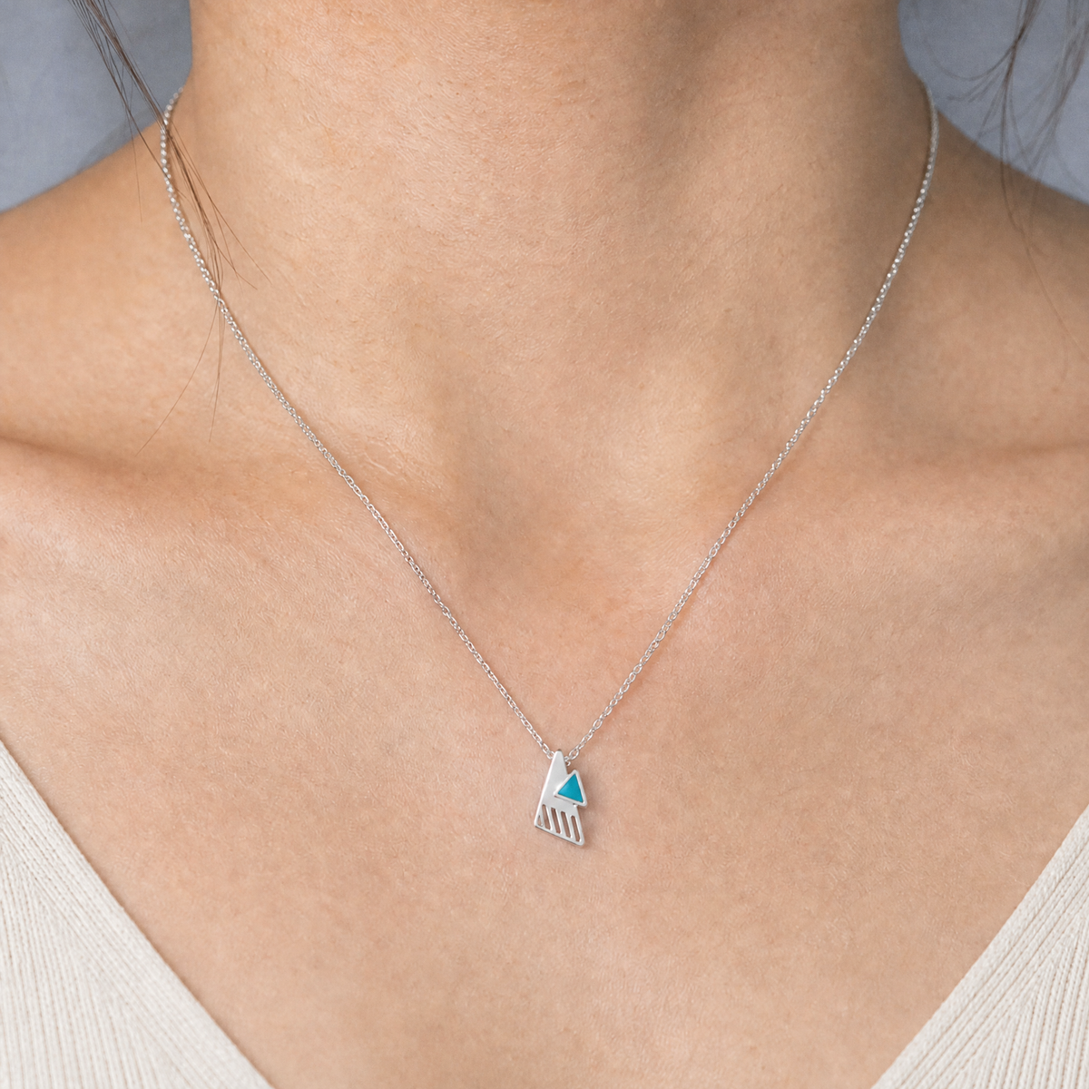 Teal Triangle Enamel Pendant Necklace in 925 sterling silver, worn at the neckline