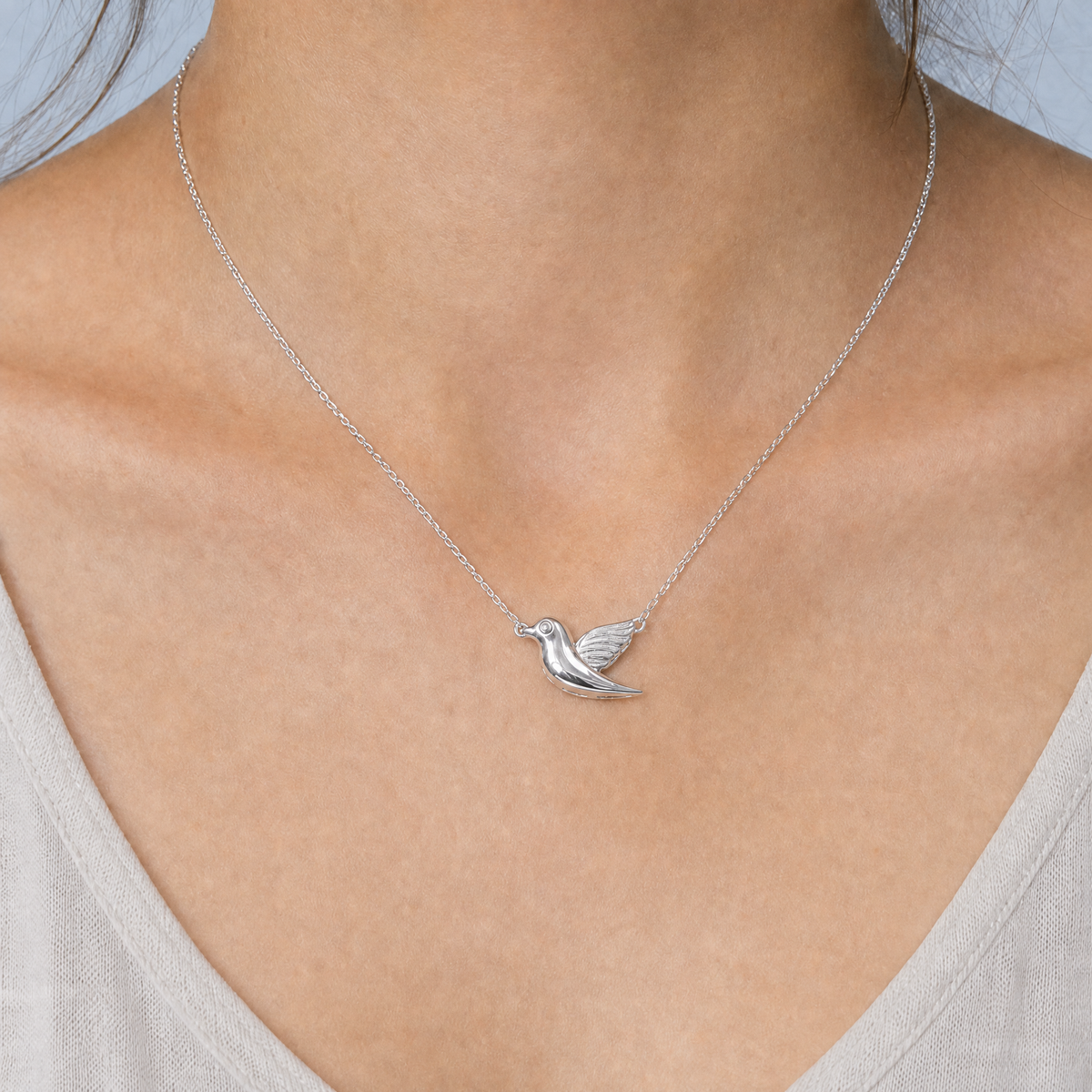 Songbird Pendant Necklace in 925 sterling silver, worn at the neckline