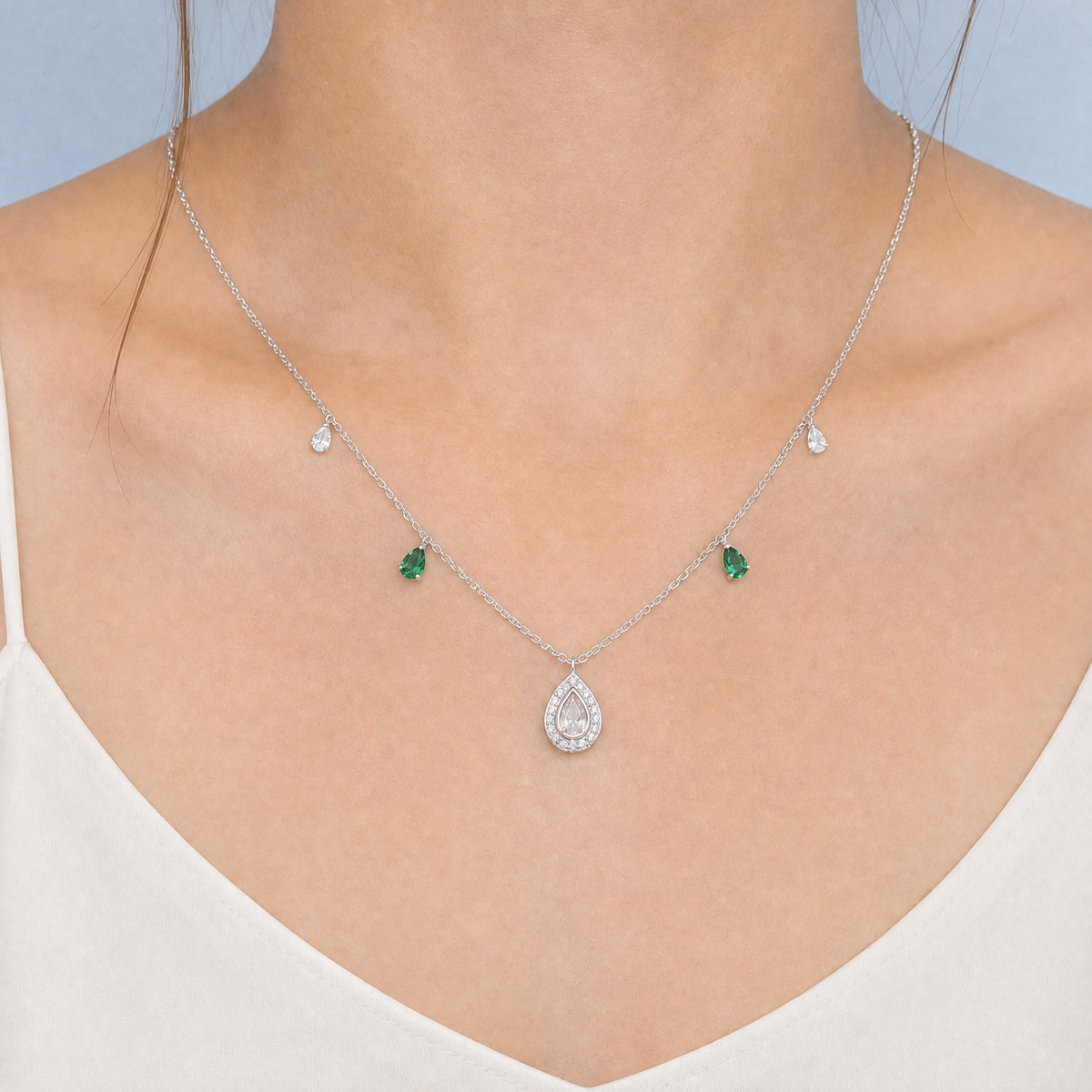 Green Accent Pear Halo Necklace in 925 sterling silver, worn at the neckline