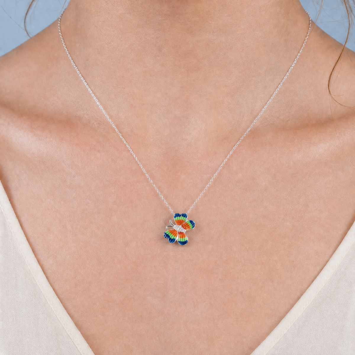 Rainbow Wing Butterfly Necklace in 925 sterling silver, worn at the neckline
