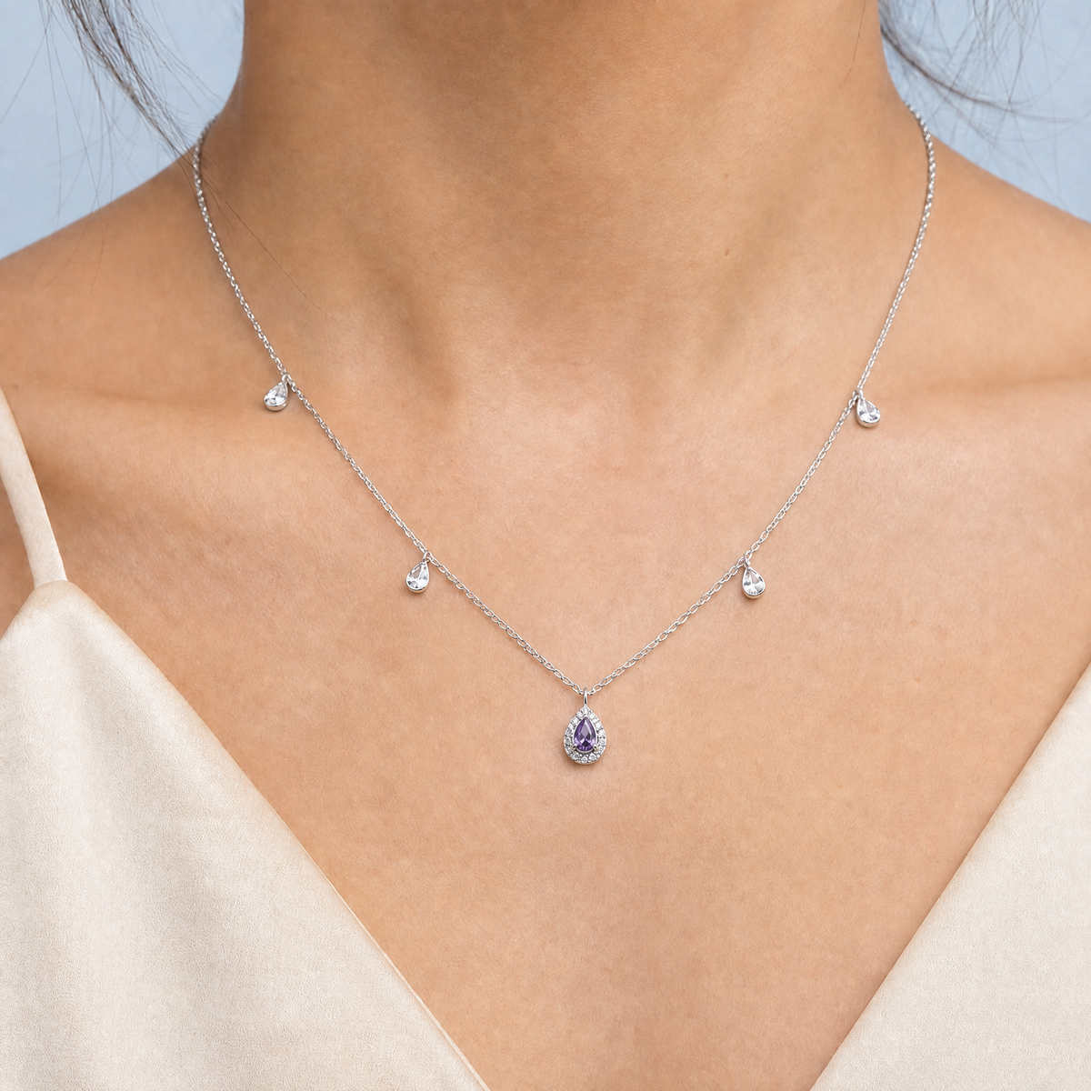 Purple Pear Halo Station Necklace in 925 sterling silver, worn at the neckline