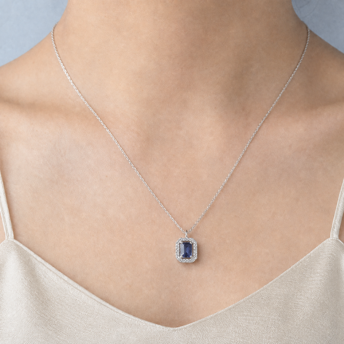 Blue Halo Pendant Necklace in 925 sterling silver, worn at the neckline