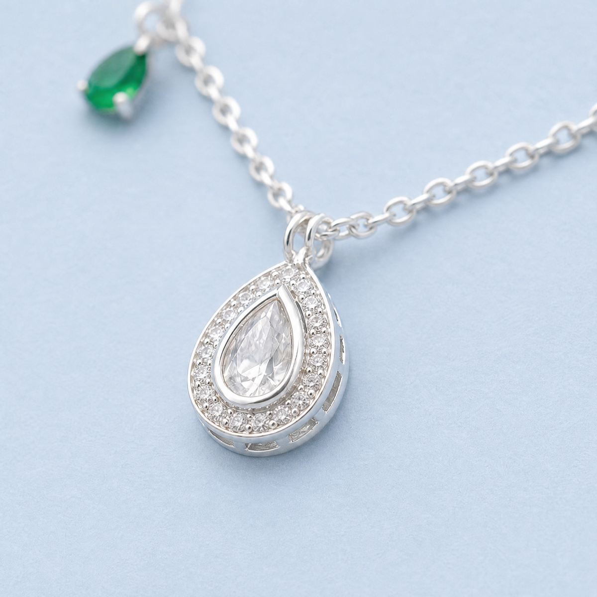 Green Accent Pear Halo Necklace in 925 sterling silver, close-up of the pendant