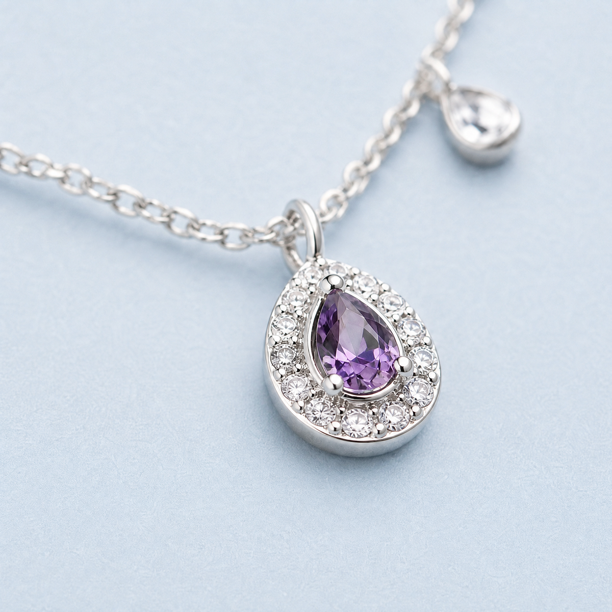 Purple Pear Halo Station Necklace in 925 sterling silver, close-up of the pendant