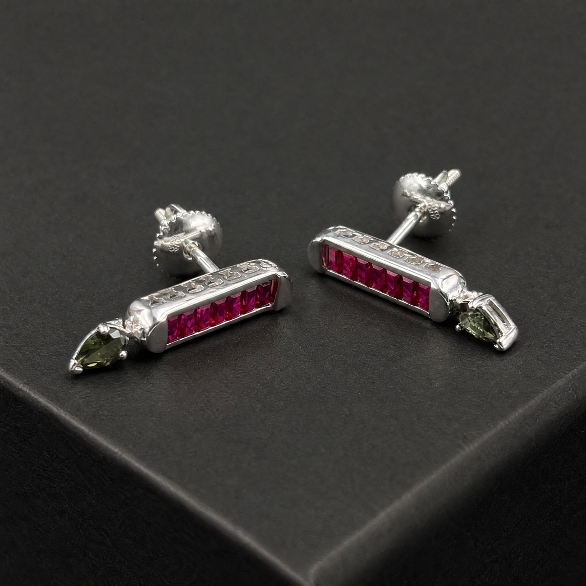 Red Baguette Bar Drop Earrings in 925 sterling silver, angled view on a dark background