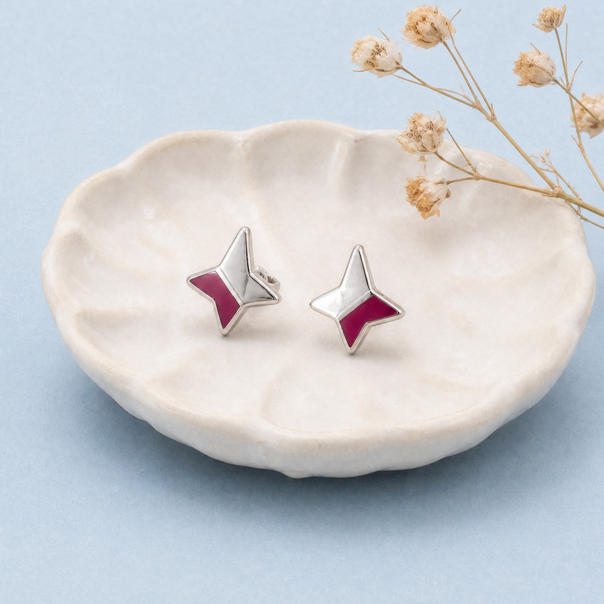 Four Point Star Enamel Stud Earrings in 925 sterling silver, on a ceramic dish