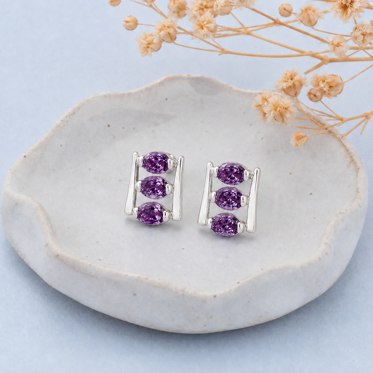 Purple Trio Ladder Stud Earrings in 925 sterling silver, on a ceramic dish