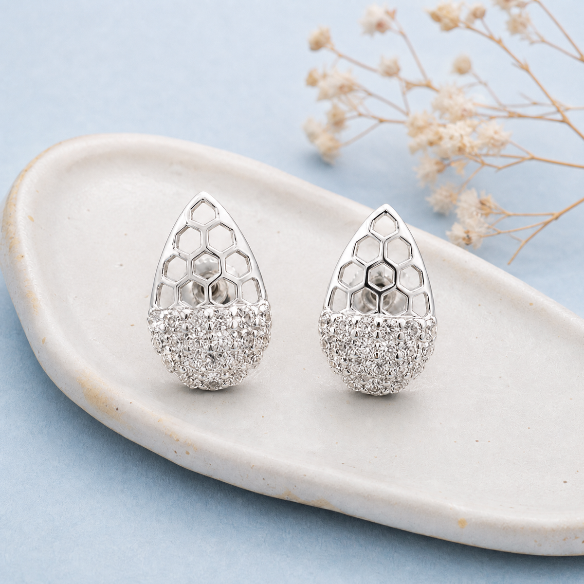Honeycomb Pavé Stud Earrings in 925 sterling silver, on a ceramic dish