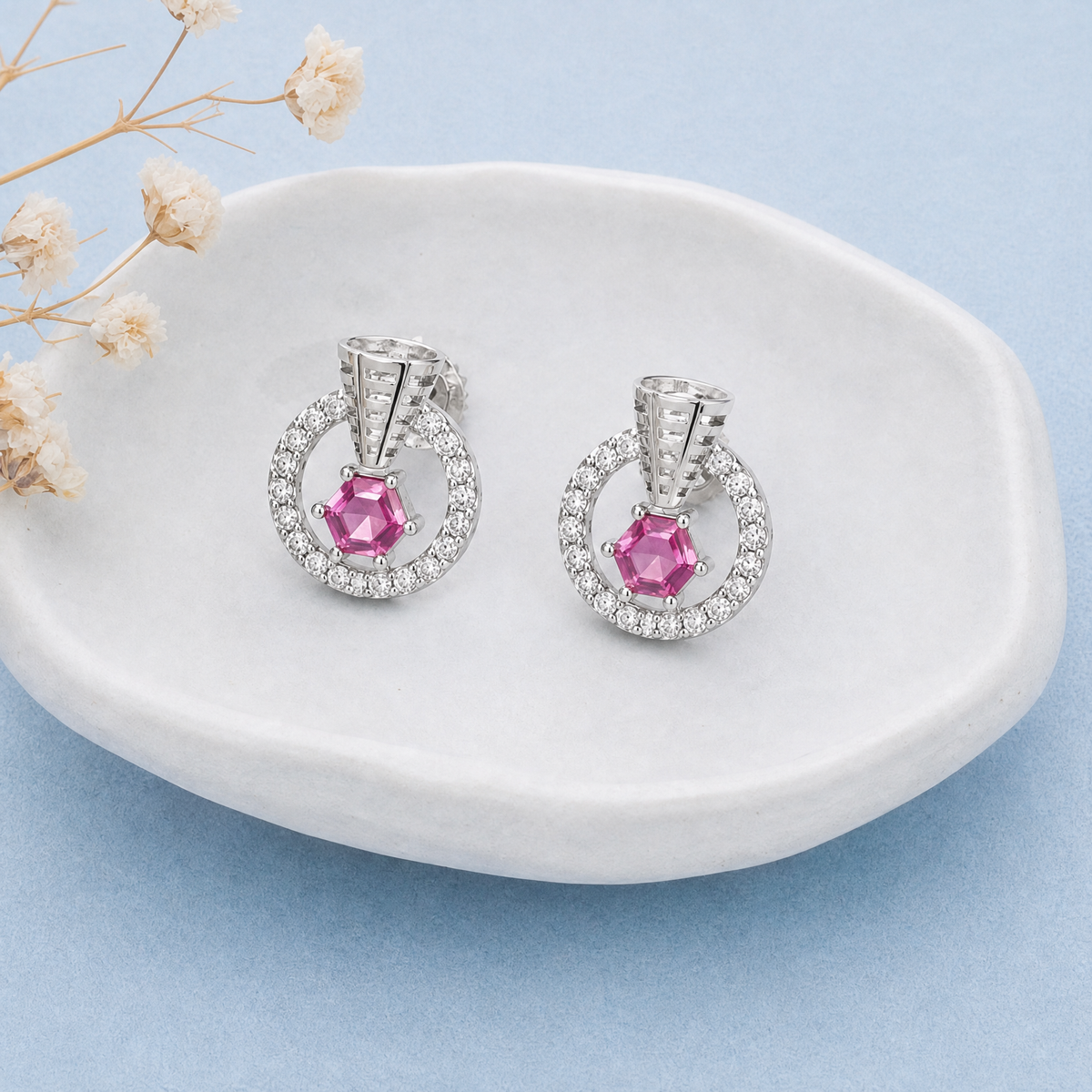 Pink Hexagon Circle Stud Earrings in 925 sterling silver, on a ceramic dish