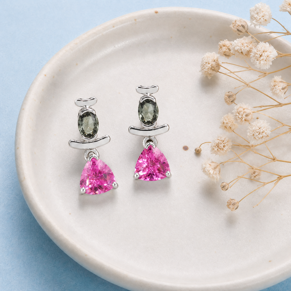 Grey and Pink Triangle Drop Earrings in 925 sterling silver, on a ceramic dish