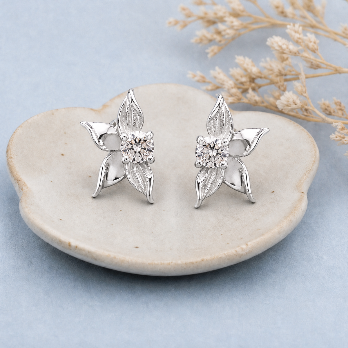 Petal Bloom Stud Earrings in 925 sterling silver, on a ceramic dish