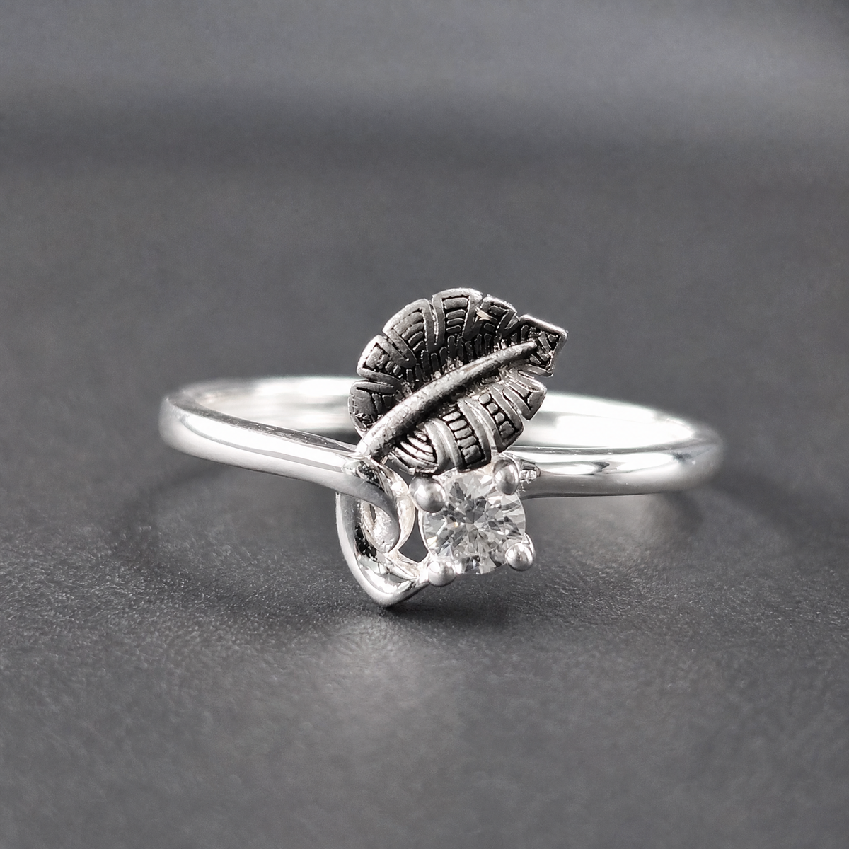 Dark Leaf Clear Stone Ring in 925 sterling silver, on a dark background