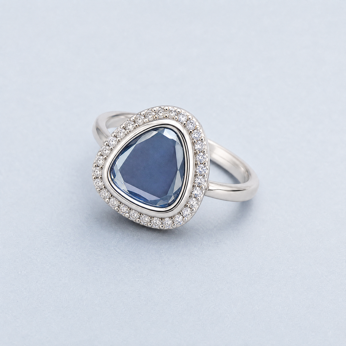 Blue Triangle Halo Ring in 925 sterling silver, angled view