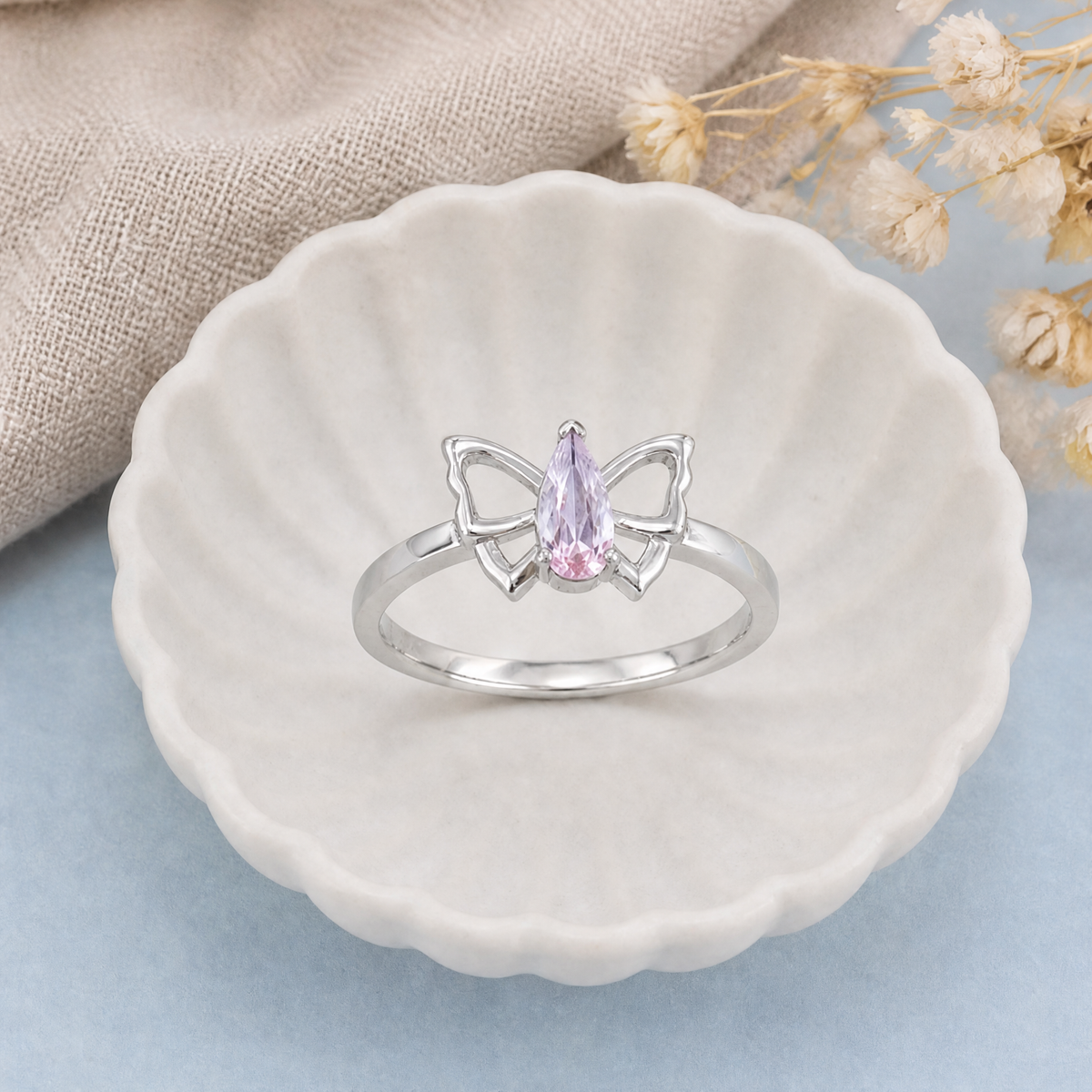 Pink Butterfly Outline Ring in 925 sterling silver, in a ceramic dish